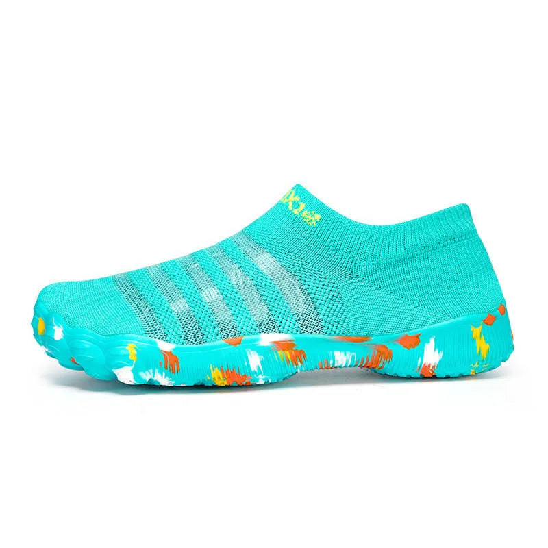 Women's Flyknit fishing line water shoes in black camouflage with front lace-up closure and rubber sole on a beach background