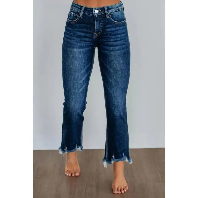Women's solid colour denim jeans in dark blue and light blue, showing casual fit and hand-worn texture.