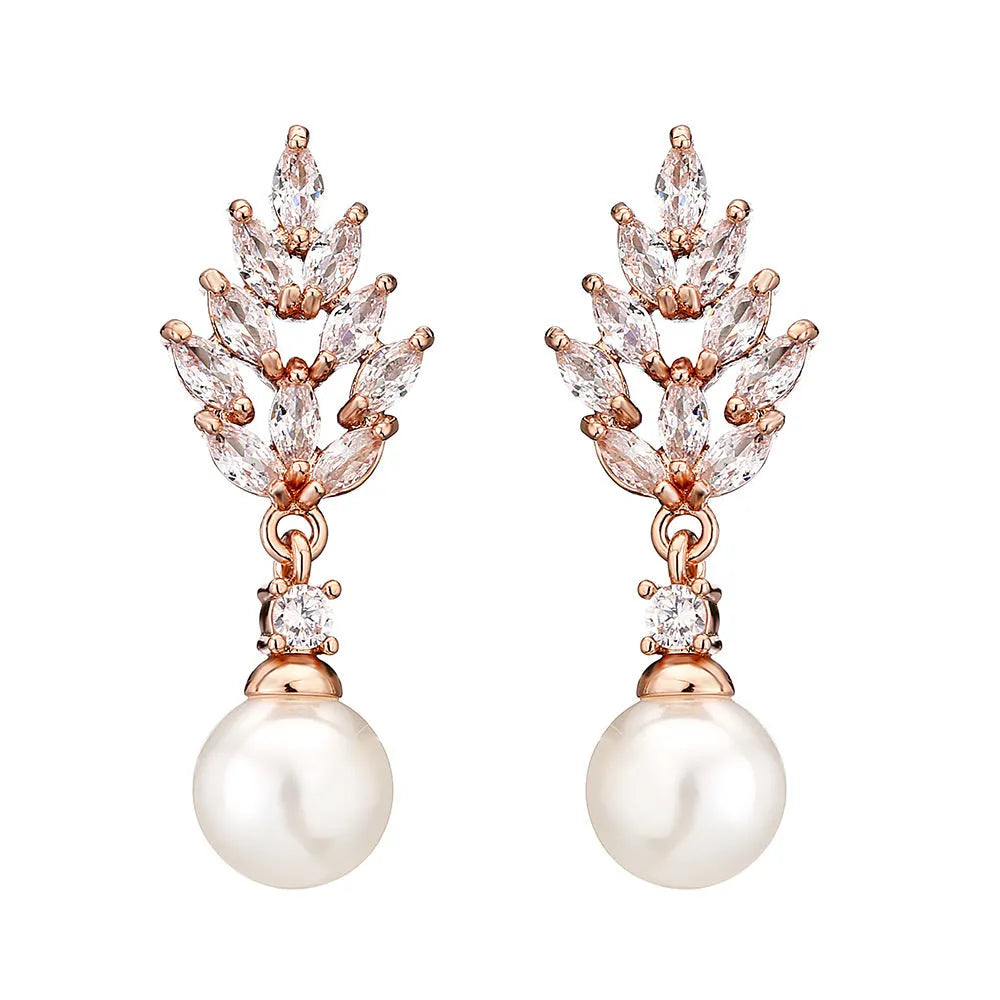 Geometric flower shaped earrings with micro inlaid zircon stones and pearl details on gold plating.