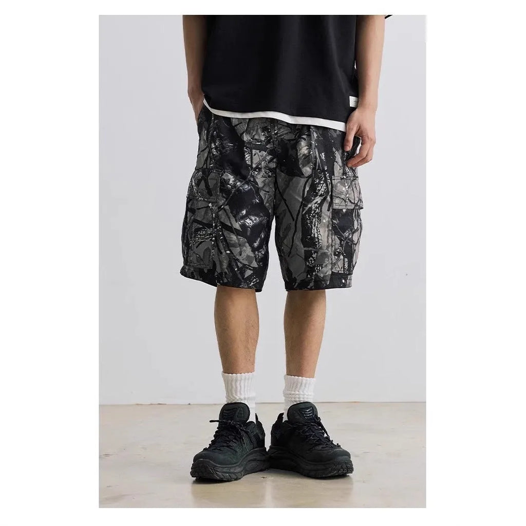 Men's loose fit straight-leg denim shorts in army green on a plain background.
