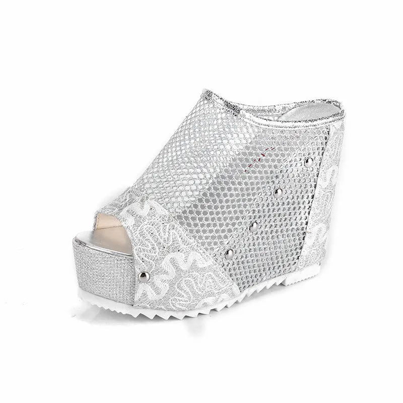 Black platform flip-flops with a chunky heel, hollowed-out design, and mesh upper on a white background.
