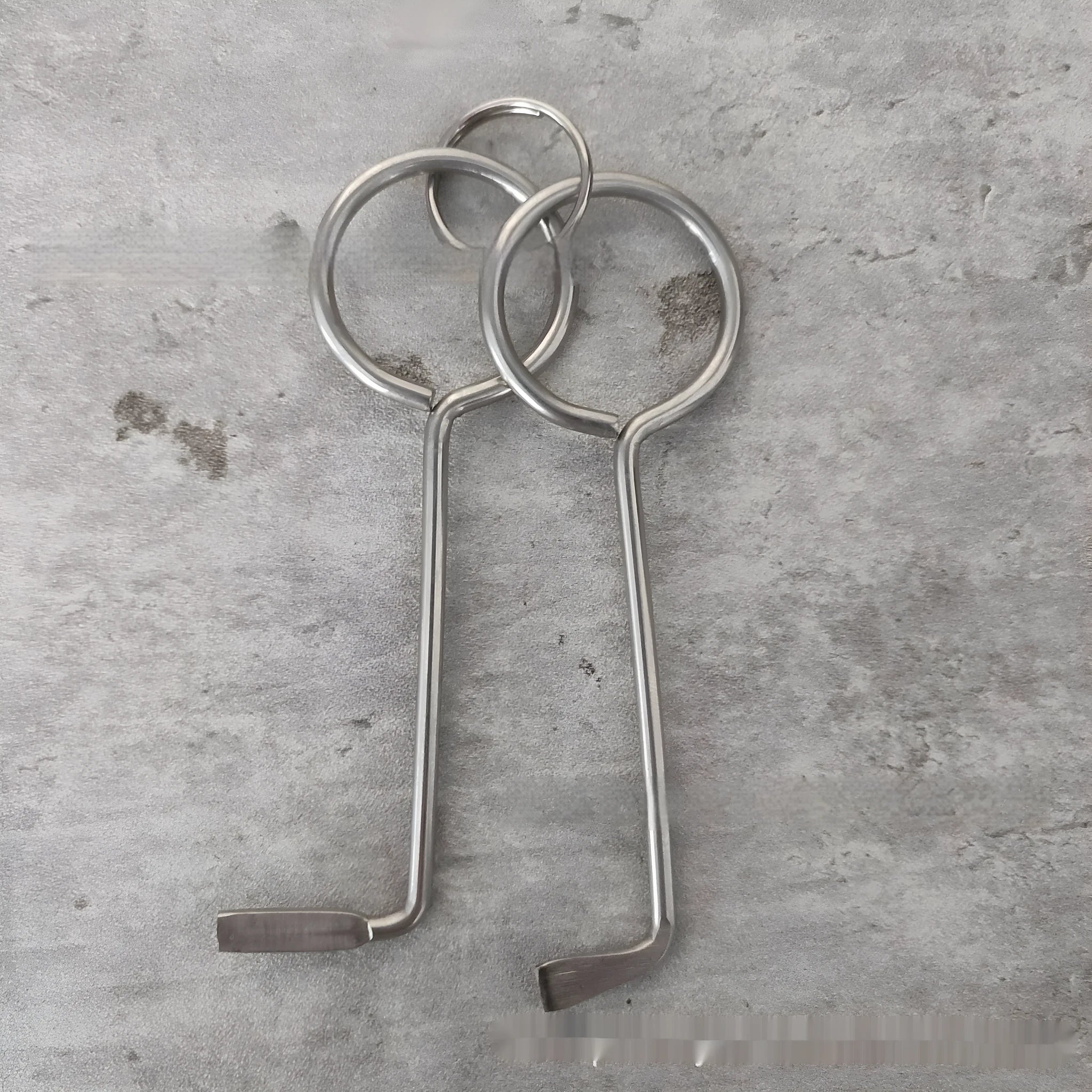 Two silver alloy wrench tools from a portable DIY and maintenance tool set.