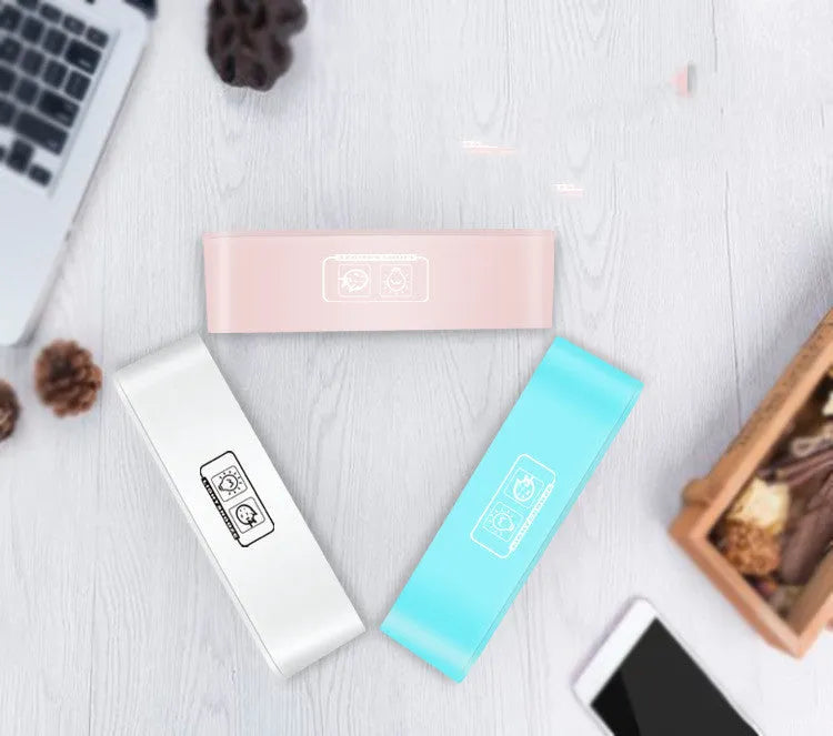 Blue rectangular LED digital alarm clock with atmosphere light on a bedside table.