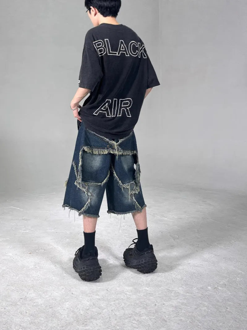 Men's blue denim shorts with loose retro fit, frayed details, and five-pointed star motif on micro-elastic cotton fabric