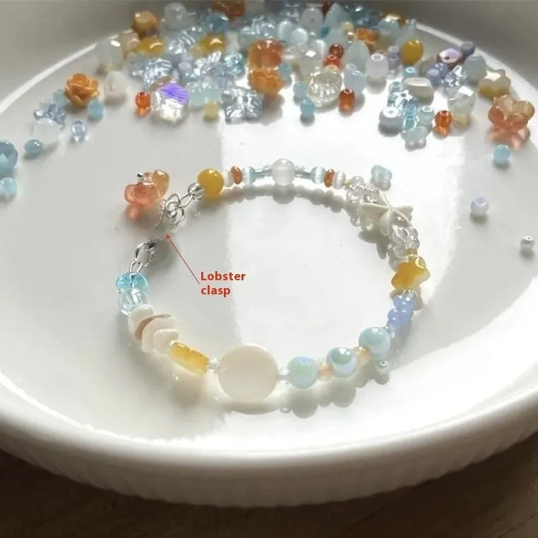 Orange alloy bracelet with diamond-shaped links and mixed material construction