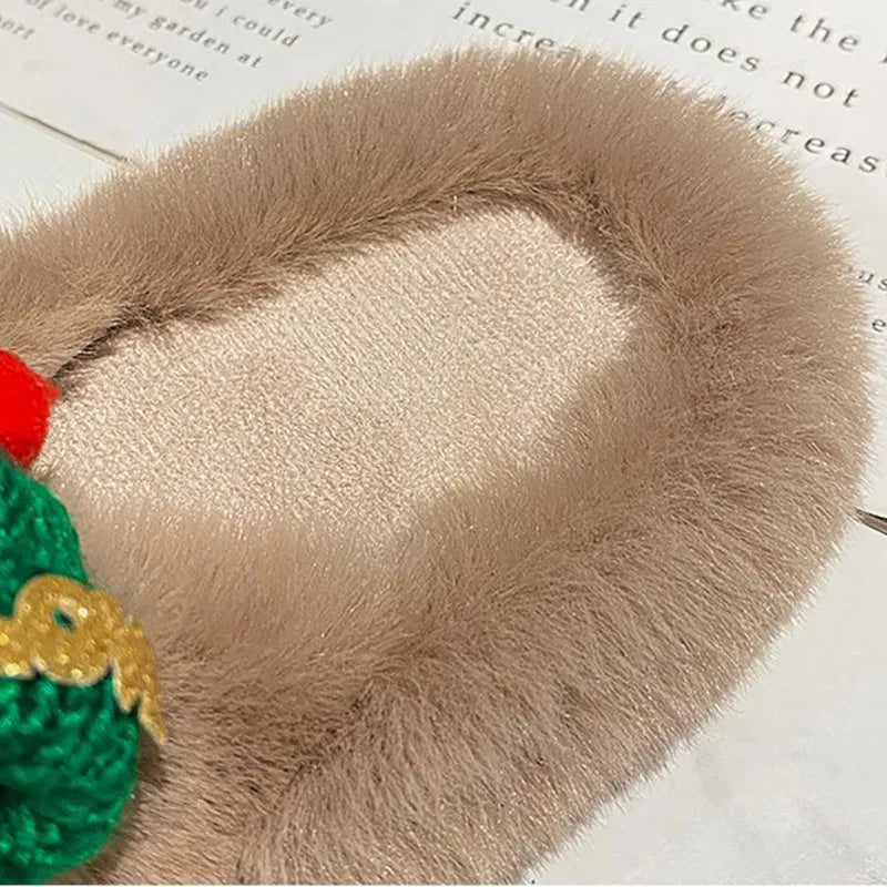 Women's slippers with a Christmas hat decoration on a super hairy faux plush upper, shown in black.