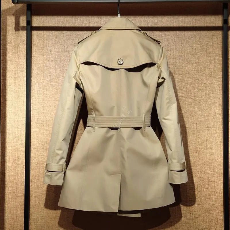 Khaki double-breasted trench coat for women with flight sleeves and button fastening.