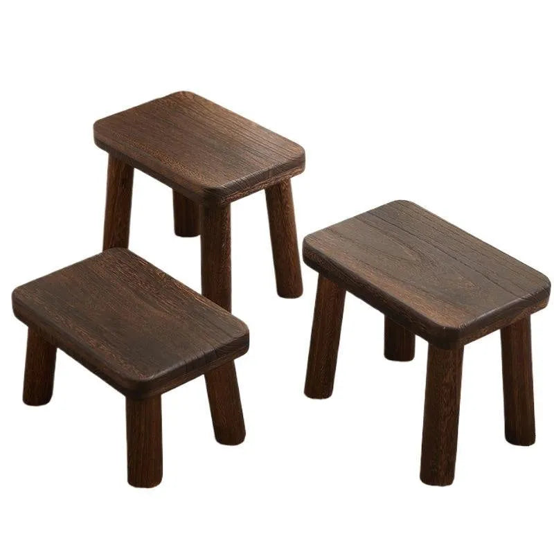 Distressed wooden stool with bracket structure legs in rustic finish