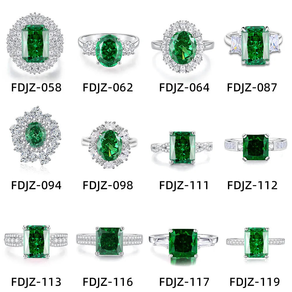 Women's oval emerald and diamond ring in sterling silver on a hand.