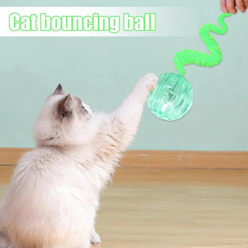 Interactive cat ball toy with plush tail in green, pink, and purple on white background