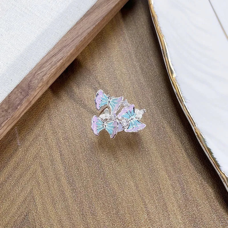 Copper insect-shaped adjustable ring with an irregular dripping oil finish.
