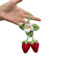 Handwoven strawberry-shaped car pendant made from natural cotton and hemp fibres.
