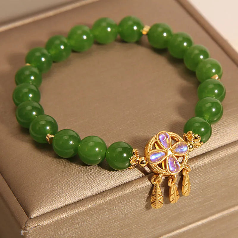 Women's green jasper crystal bracelet with four-leaf clover and dream catcher pendant, original design, on white background
