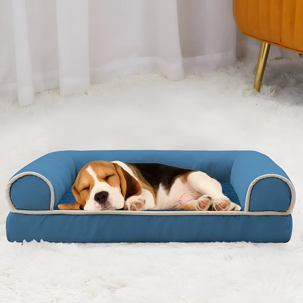 Breathable square sponge dog bed for pets in blue colour, shown in a home setting.