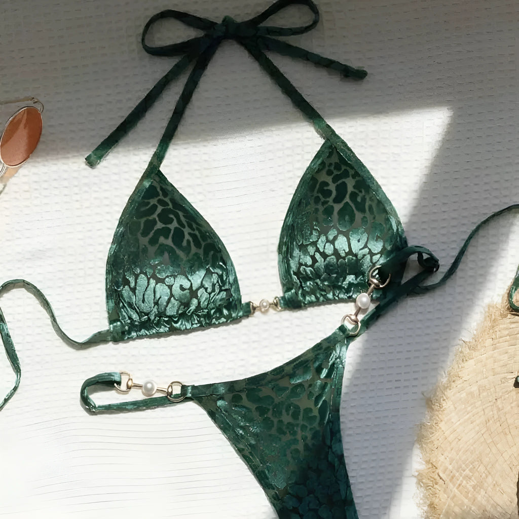 Women's blue leopard print bikini set on a yellow background, showing triangle top and briefs style.
