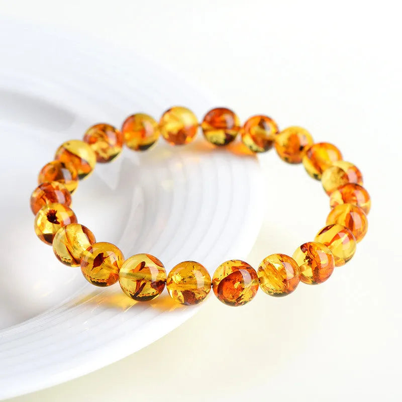 Natural yellow piebald amber bracelet with flower spot patterning and geometry beads