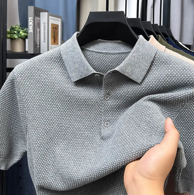 Man wearing a loose grey cotton short sleeve pullover sweater for casual leisure.