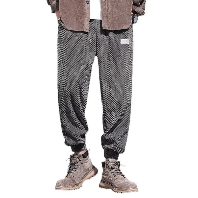 Grey men's straight-leg sweatpants with ankle ties laid flat.