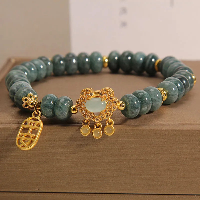 Natural emerald jade abacus bead safety lock style bracelet on women's wrist, alloy frame, green gemstone beads