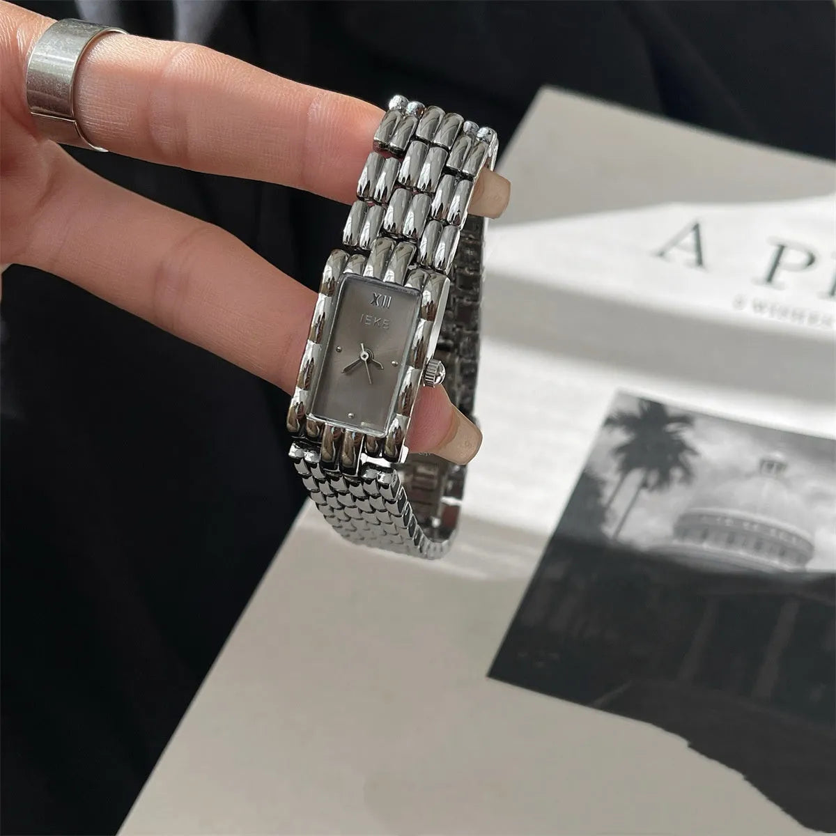 Slender 7mm thick women's mid-century bracelet watch with butterfly buckle on wrist.
