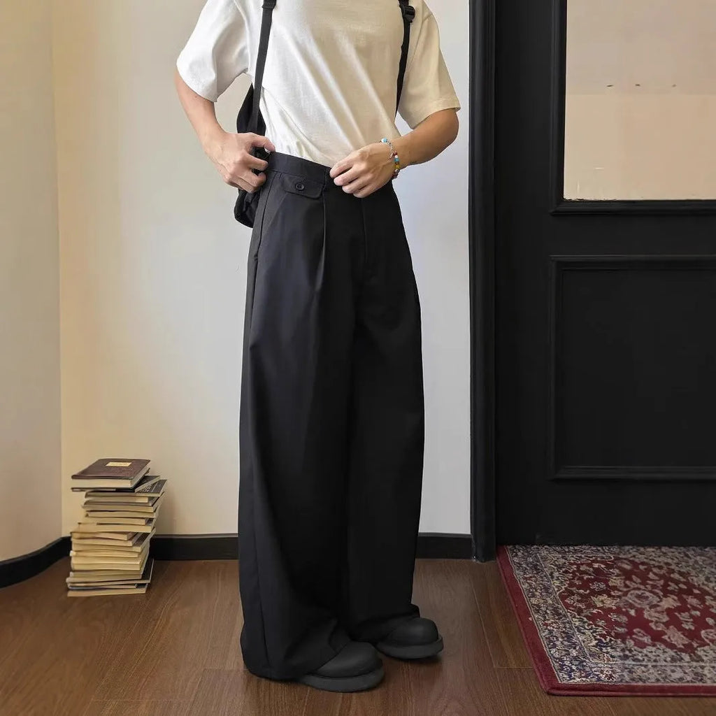 Men's brown straight-leg casual suit trousers with a loose, wide-leg fit on a hanger.