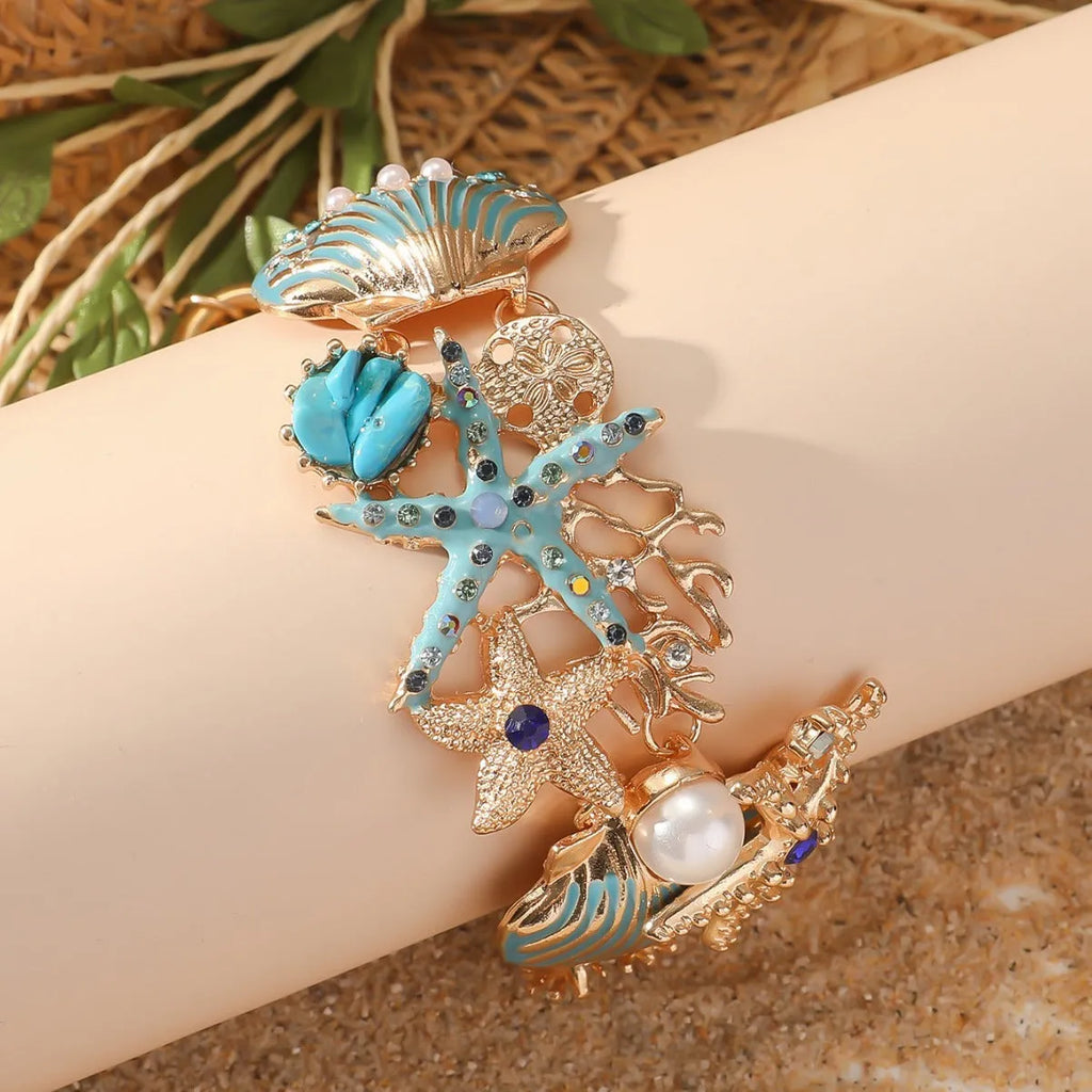 Women's alloy bracelet with a boat anchor charm, starfish, and rhinestones in turquoise, red, or blue.
