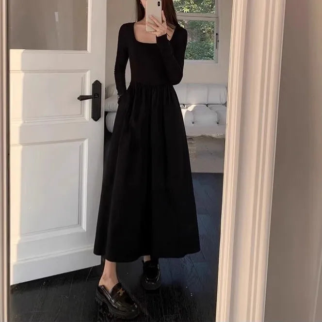 Black knitted square collar dress with long sleeves and an A-line long skirt on a model.