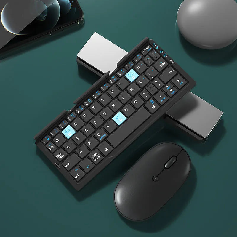 Silver white folding Bluetooth keyboard open beside smartphone showing aluminium stand