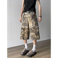 Yellow snake pattern camouflage cropped jeans showing detailed tooling print and denim construction