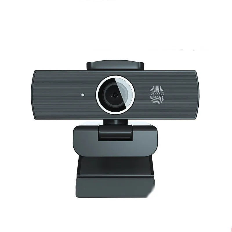 Black USB computer webcam with magnetic privacy cover on a desktop
