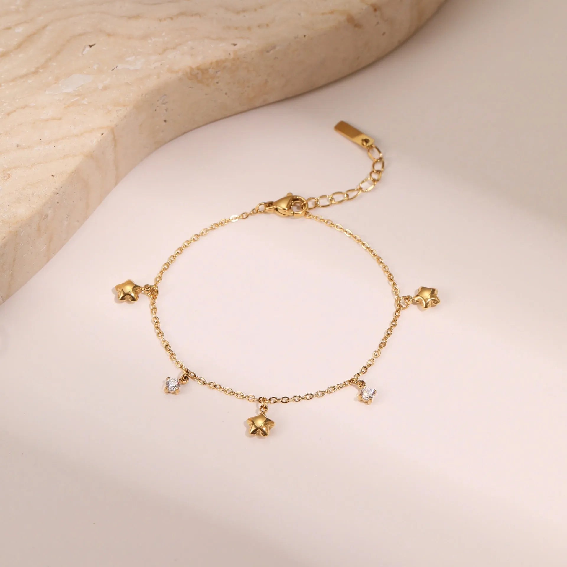 Gold-plated titanium steel women's bracelet with a geometric hexagonal star zircon pendant.