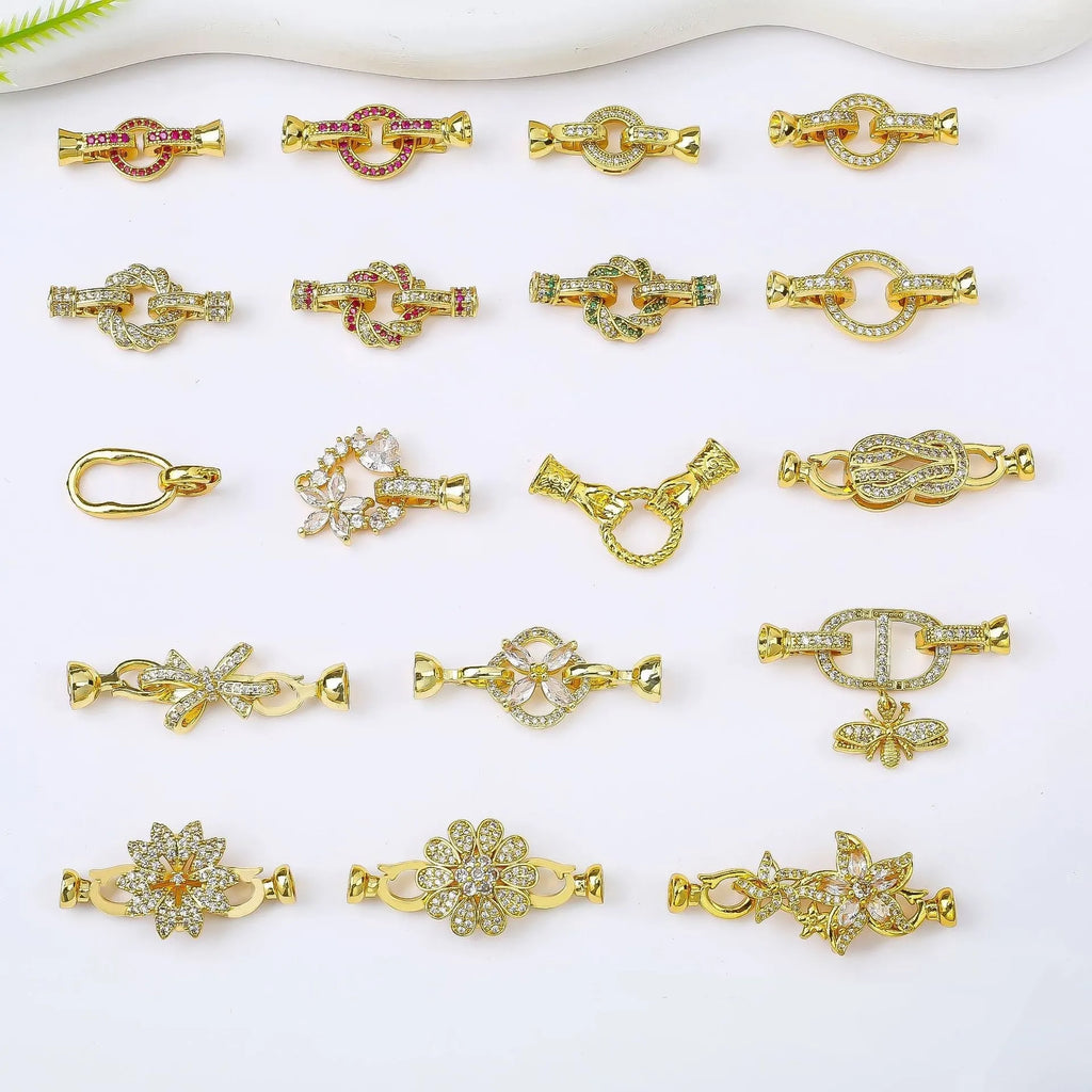 Small gold-coloured metal jewellery clasp on a white background.