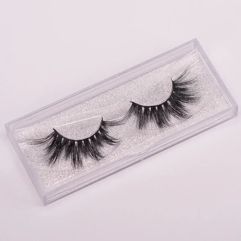 5D mink hair false eyelashes set with applicator brush and storage cap on white background