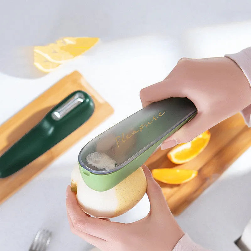 Dark green kitchen peeler with storage tube and stainless steel blade for fruits and vegetables