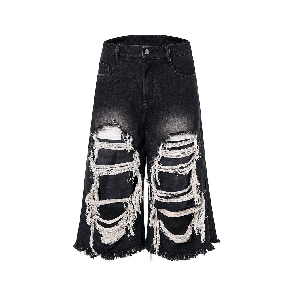 Black cropped wide-leg women's jeans with ripped patch detail on the knee.