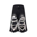 Black cropped wide-leg women's jeans with ripped patch detail on the knee.