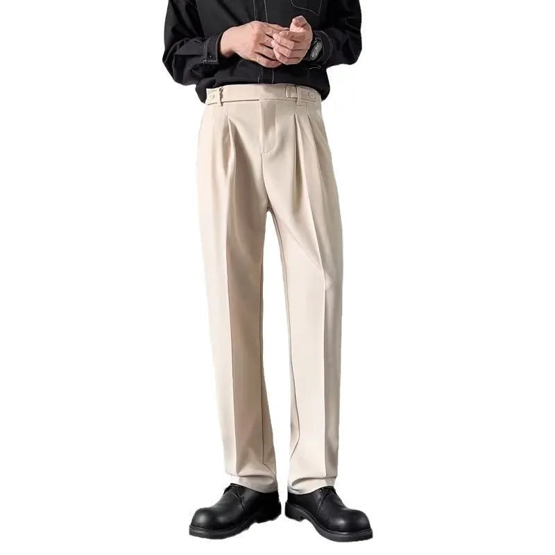 Men's apricot and black straight-leg suit trousers with a loose fit on a hanger.