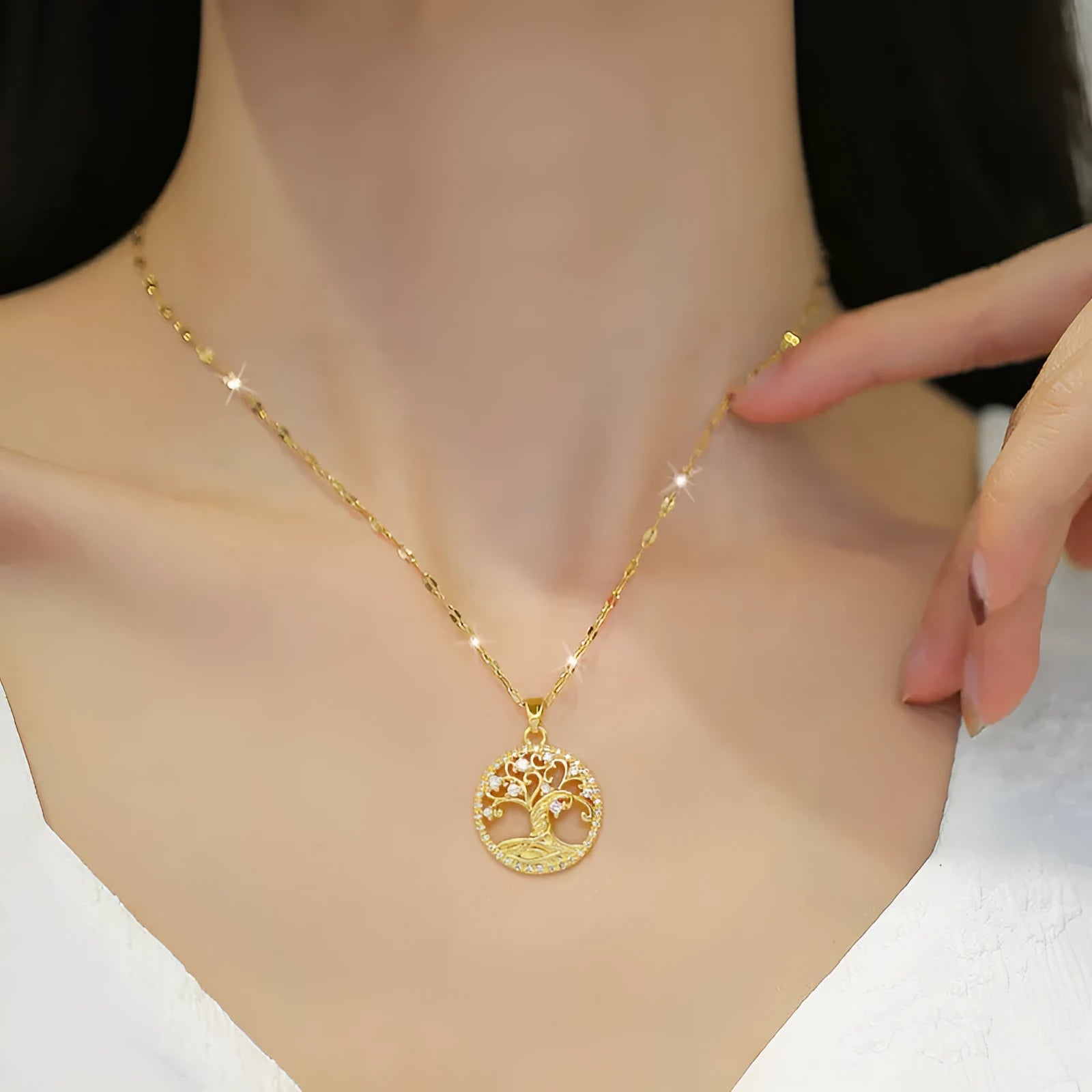 Gold-plated necklace with a detailed rhinestone lucky tree pendant on a Mother Pearl base.