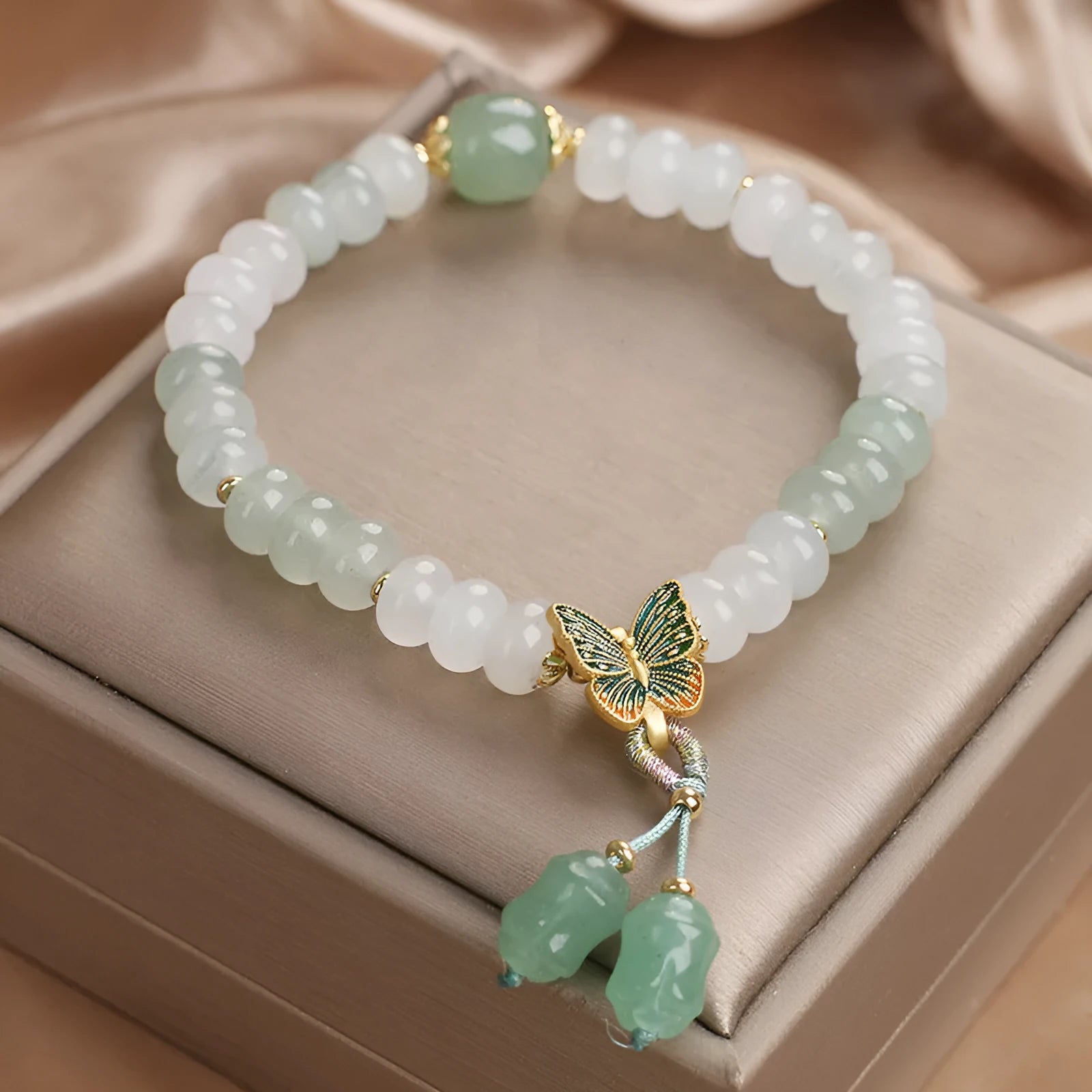 Tian Shan Cui green crystal abacus beads bracelet with butterfly tassel and pearl rhinestone sequin details, 17cm
