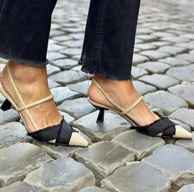 Apricot and black women's stiletto sandals with a buckle strap and pointed toe.
