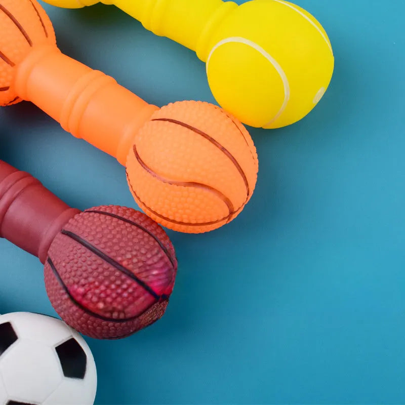 Colourful PVC football dumbbell shaped dog toy on a plain background.