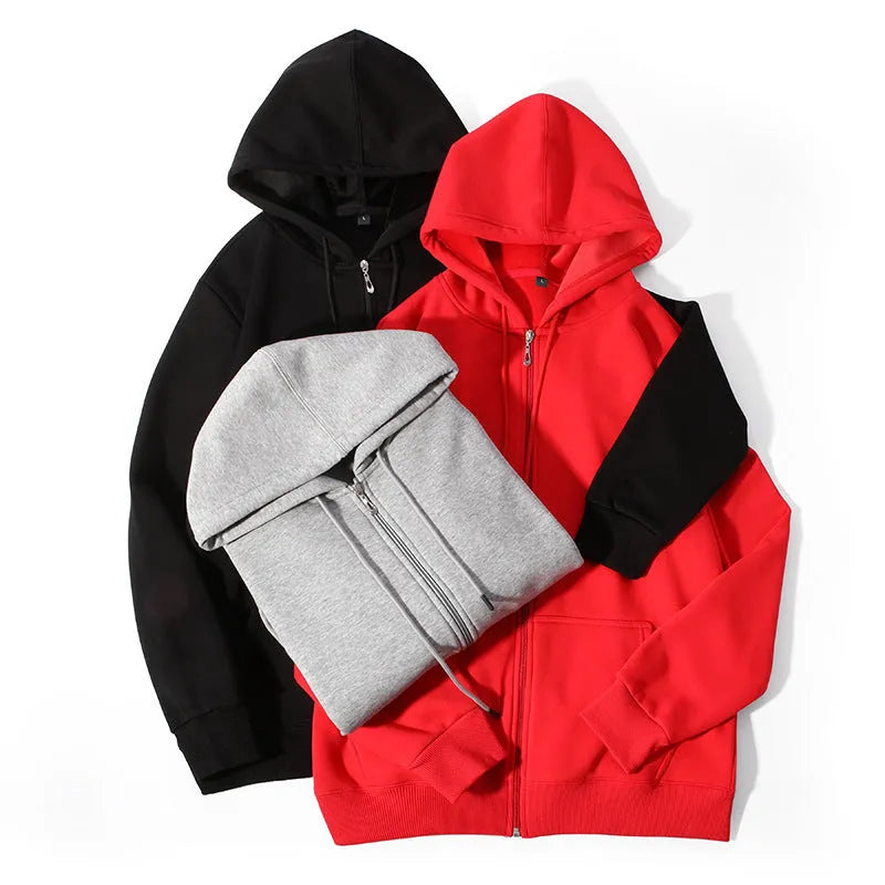 Man wearing a beige heavyweight zip-up hooded sweater, showing the front zip, hood, and top-stitch pocket detail.