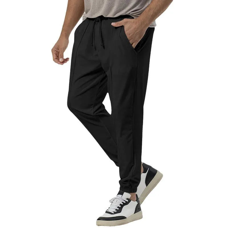 Men's grey cotton blend track sweatpants with elastic waistband and straight-leg tapered design