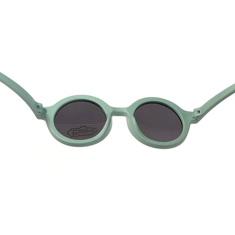 Round frame polarised sunglasses for toddlers aged 0-3 years with UV400 protection, shown in multiple colour options.