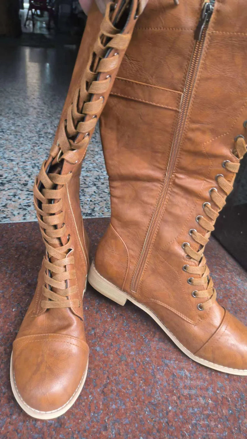 Women's black artificial PU knight boots with cross strap and lace-up closure on a size label.