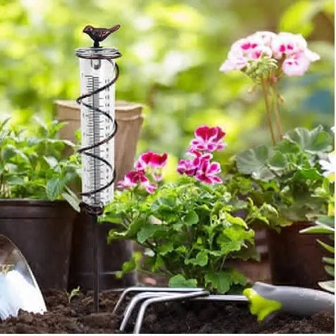 Garden rain gauge with cast iron bird decoration showing 0-800ml measurement scale