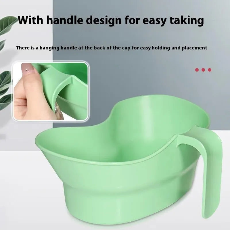 Green plastic gargle cup for bedridden patient oral care on bedside table