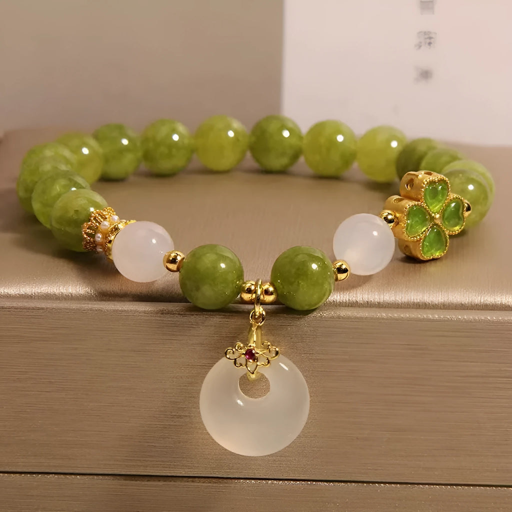 Natural stone green tourmaline women's bracelet with peace buckle and lucky bag charm on display