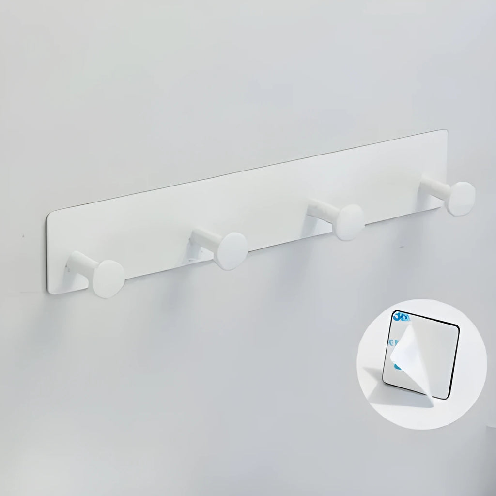 Iron screwless wall hook with multiple hooks mounted with adhesive tape on a glass shower door.