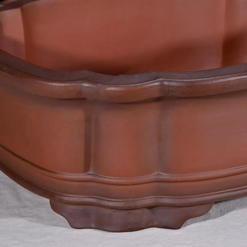 Large antique-style purple clay flowerpot with Chinese design for outdoor garden use.